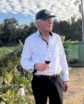 man with a wine glass in a vineyard